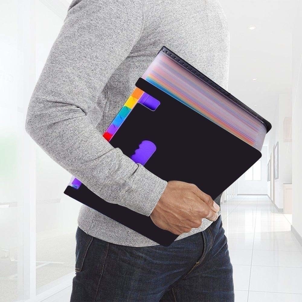 A man in a grey shirt carrying a rainbow expanding folder