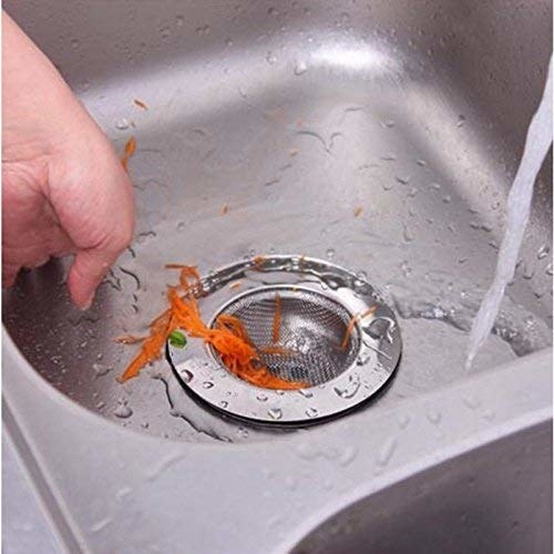 A sink with a drain cover and food items in it 
