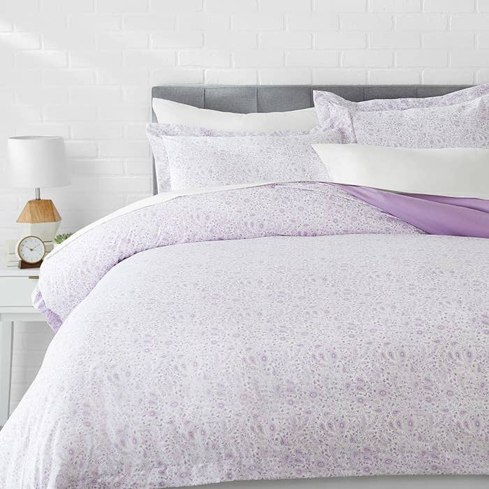 A lavender duvet cover on a bed.