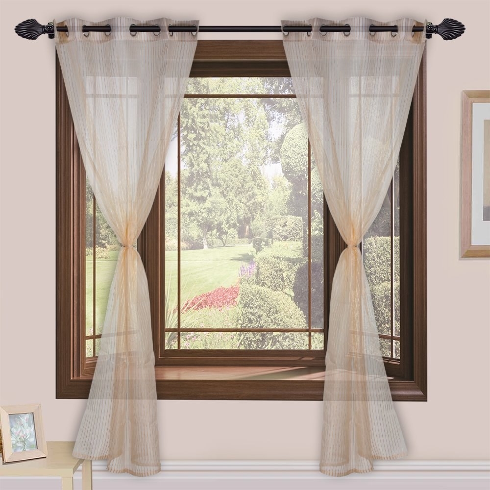 Beige sheer curtains on a window 