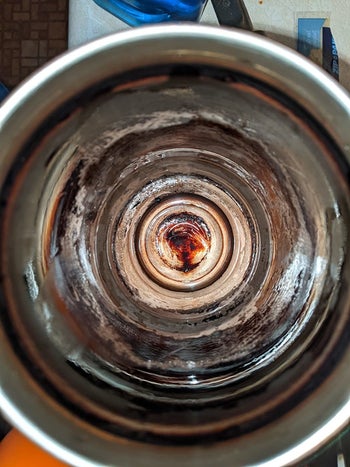 reviewer image of the inside of dirty bottle, caked with grime