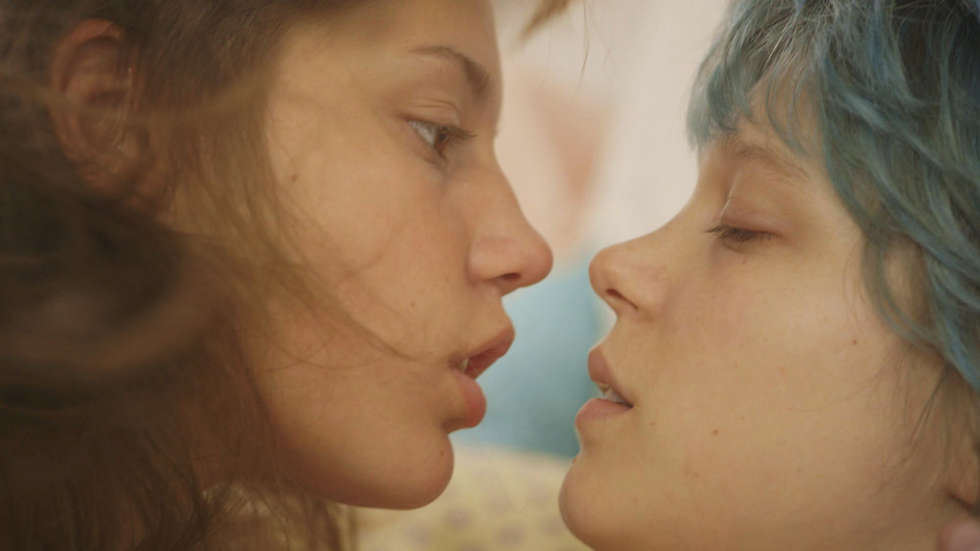 The two actresses in blue is the warmest color about to kiss