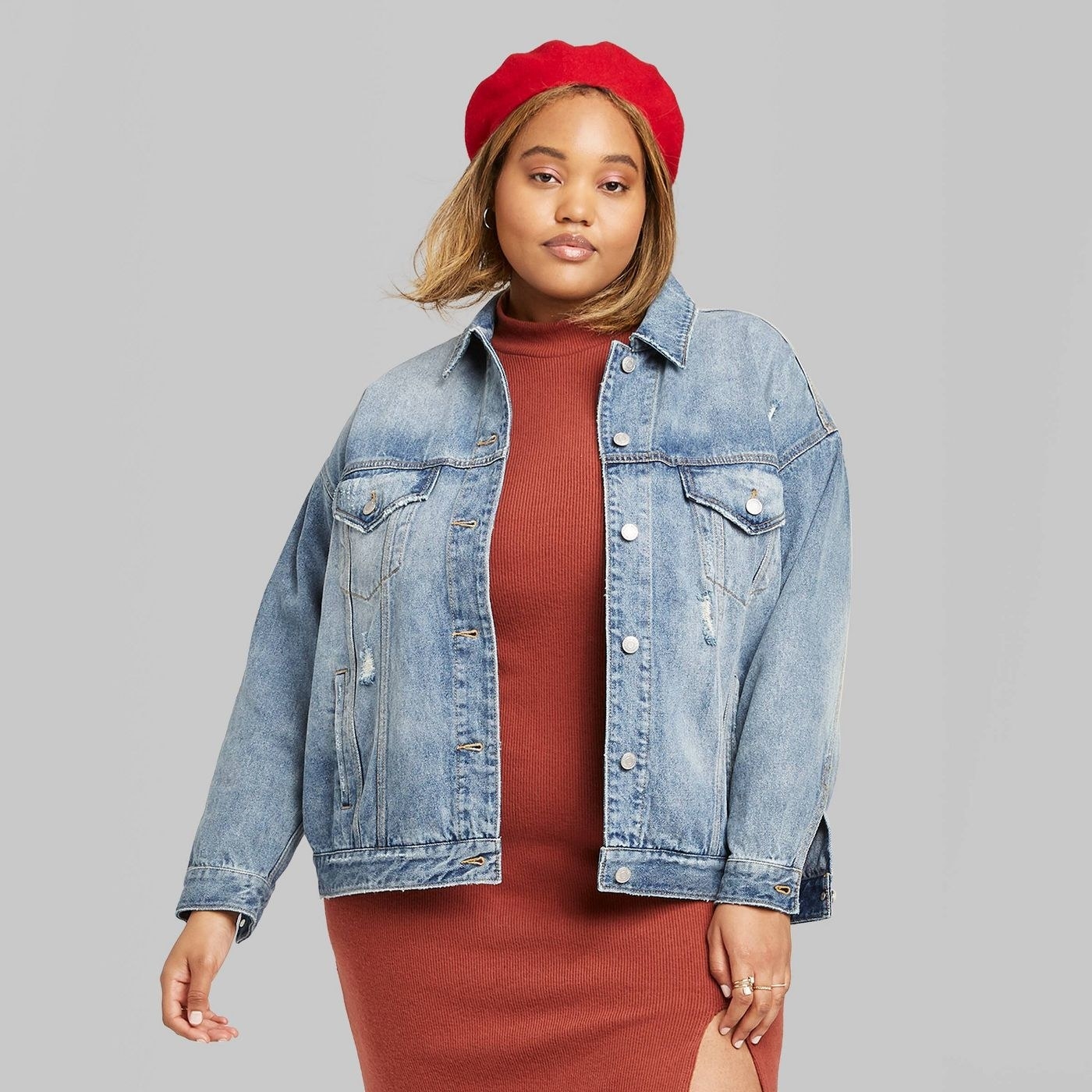 Model medium wash jean jacket with pockets on the bust area