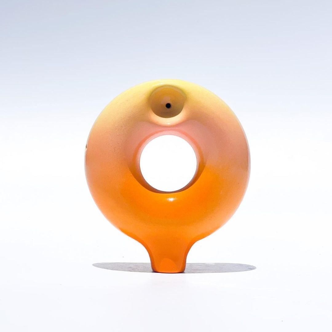 a donut pipe in an orange ombre to yellow