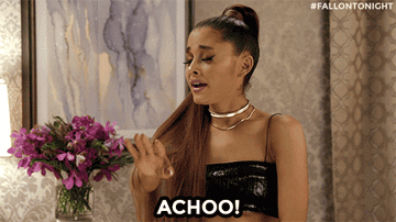 Ariana Grande sneezes and her ponytail hands her a tissue