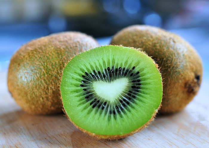 Two kiwis and one sliced in half