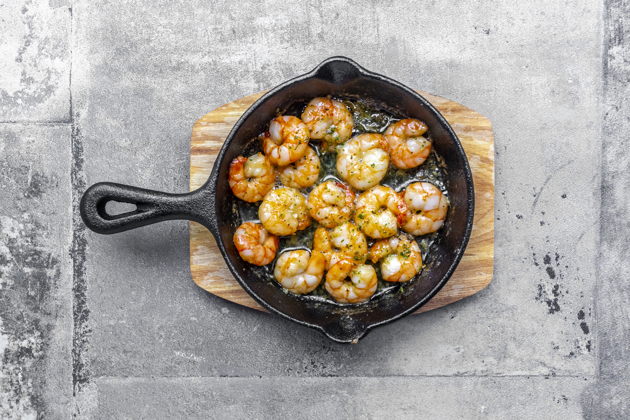 A skillet of cooked shrimp