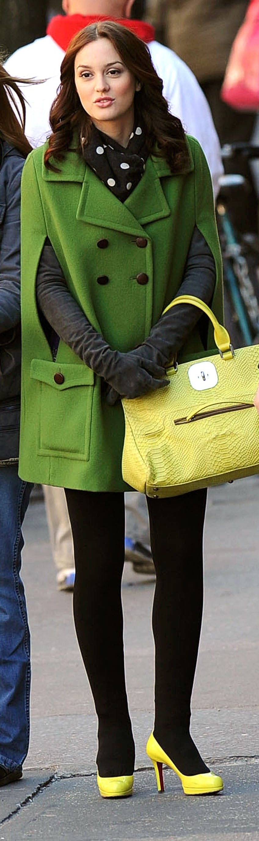 Blair in dark tights, neon shoes, a polka dot scarf, long suede gloves, a neon purse, and a bright cape peacoat