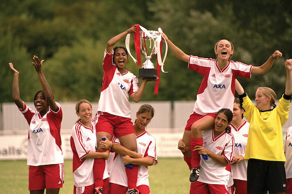 Parminder Nagra and Keira Knightley being hoisted up by their teammates as they hold a trophy