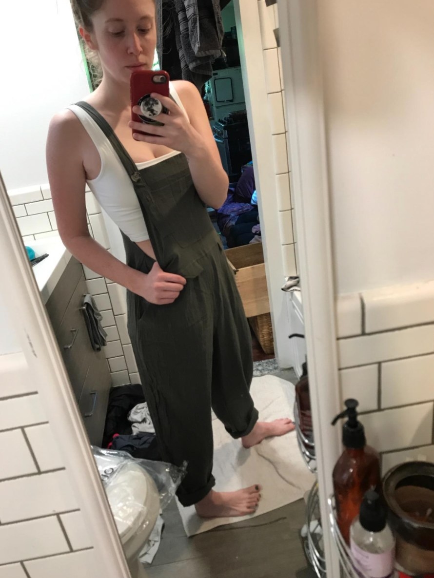 The pair of casual baggy overalls on a model in green