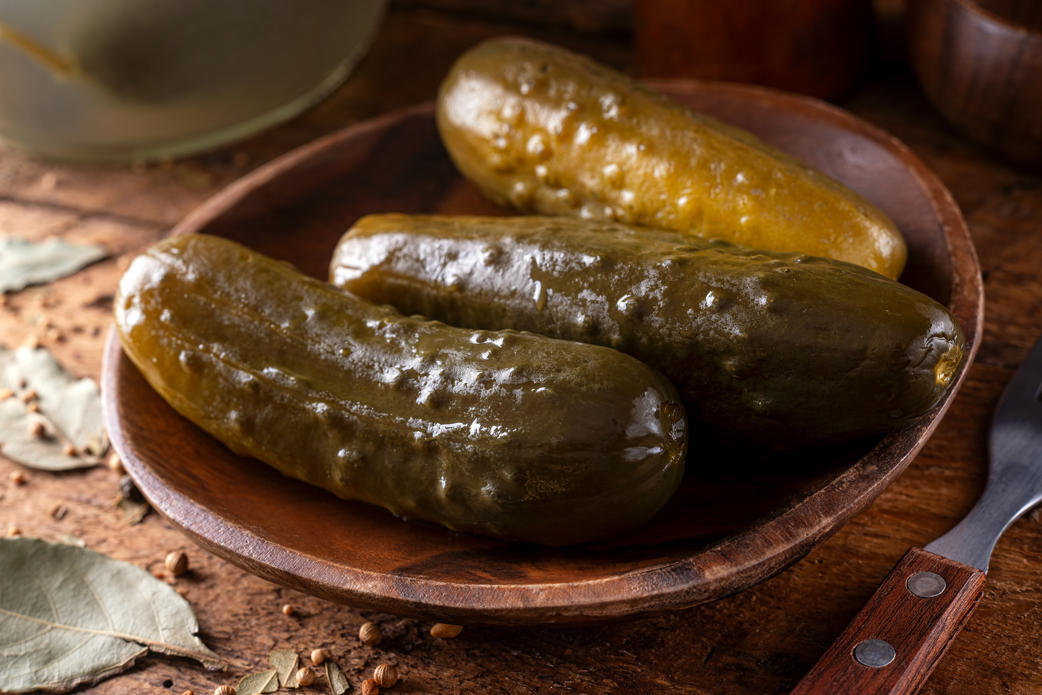 Three pickles in a bowl