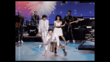 GIF of Ron dancing on a stage, and Russell swinging his arms in a music video
