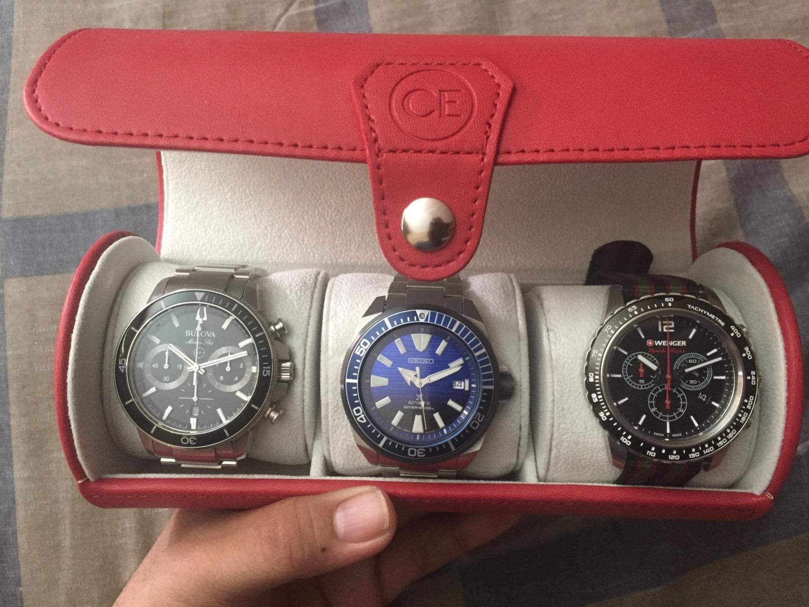 reviewer photo of the red watch roll open containing three watches