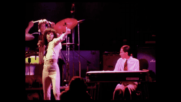 GIF of Sparks performing in the 1970s, with Russell punching the air and Ron at the keyboard