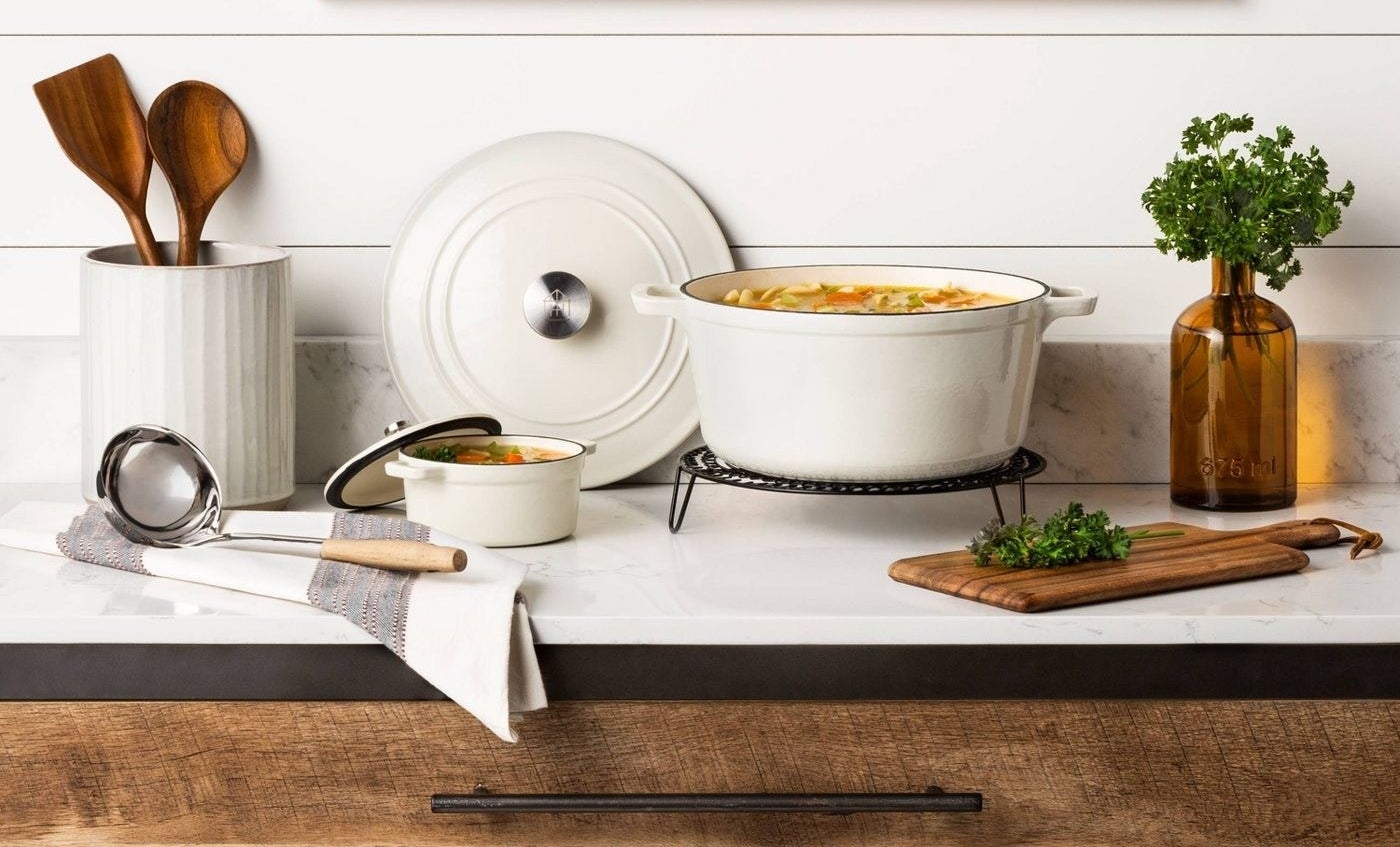 A .5-qt and 5-qt cast iron dish are shown, each filled with vegetable soup
