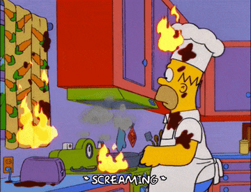 Homer Simpson starts a small fire while cooking