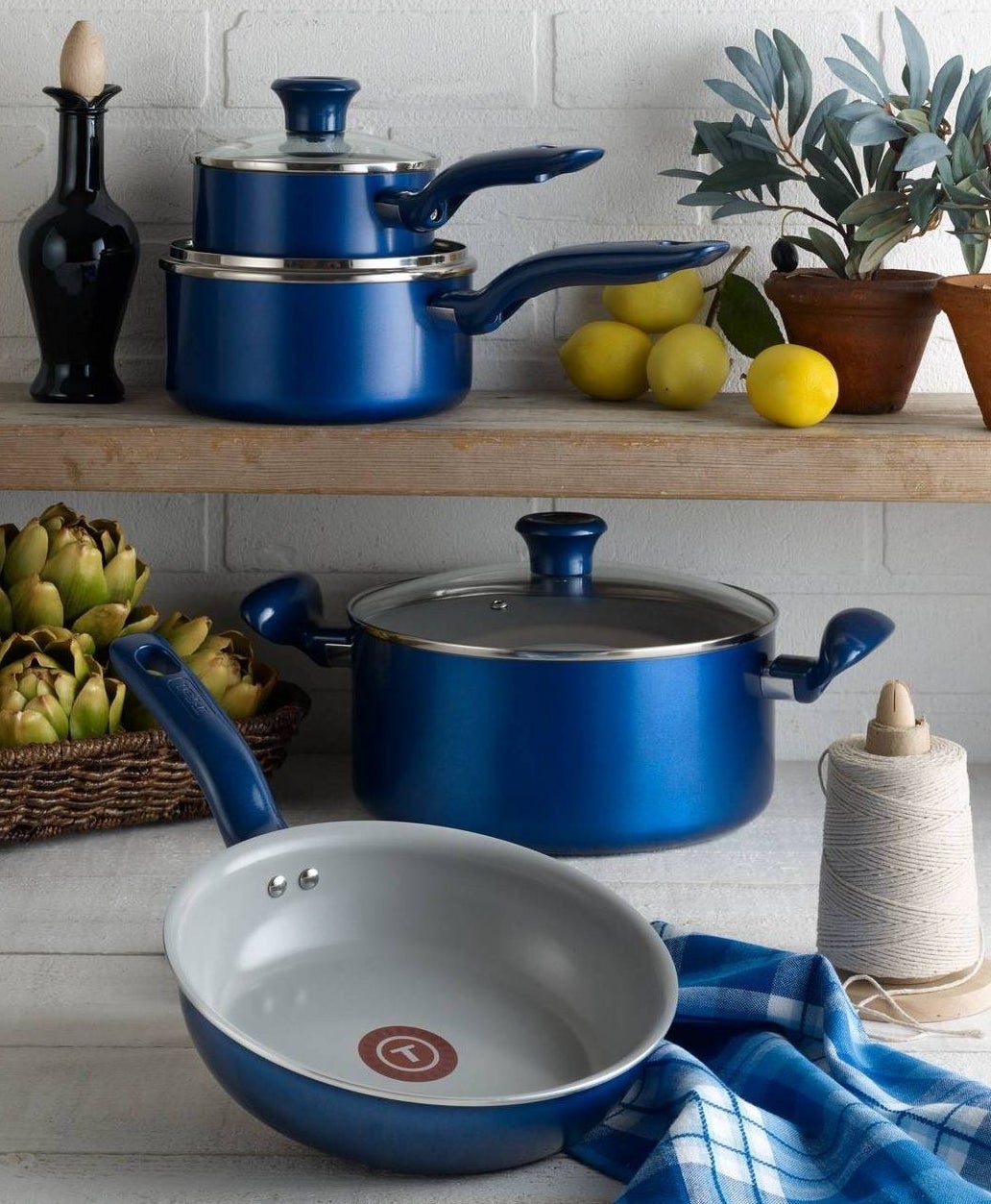 Four pieces of the cookware set are displayed in the kitchen