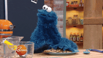 Cookie monster destroys cookies while Rachael Ray imitates