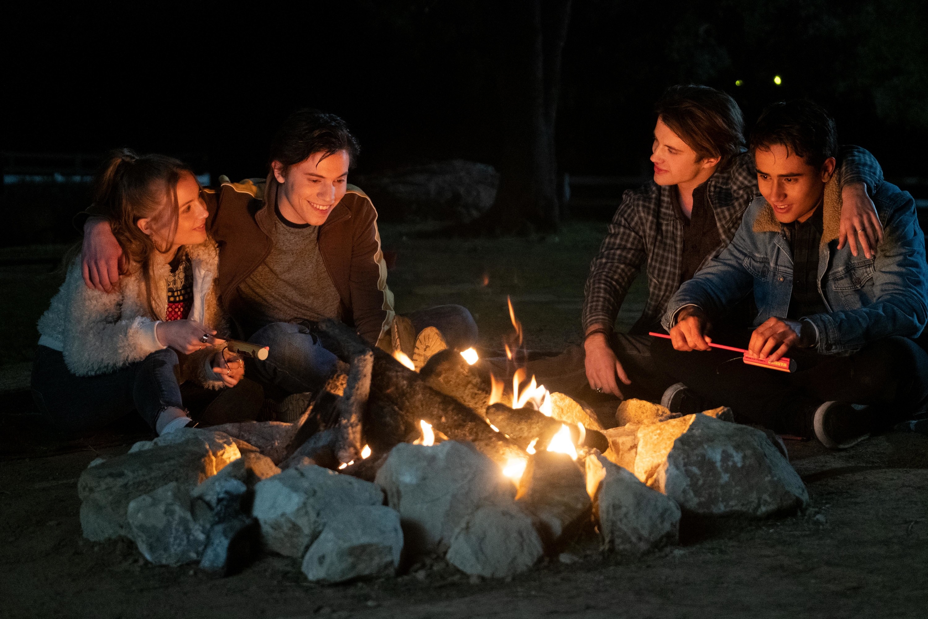 A scene with several members around a campfire