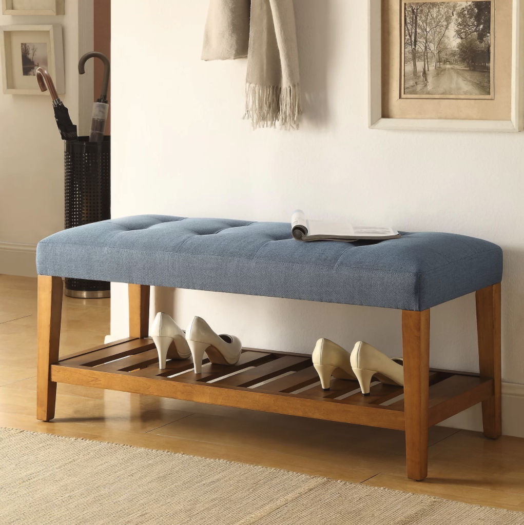 light blue upholstered storage bench with a shelf on the bottom 