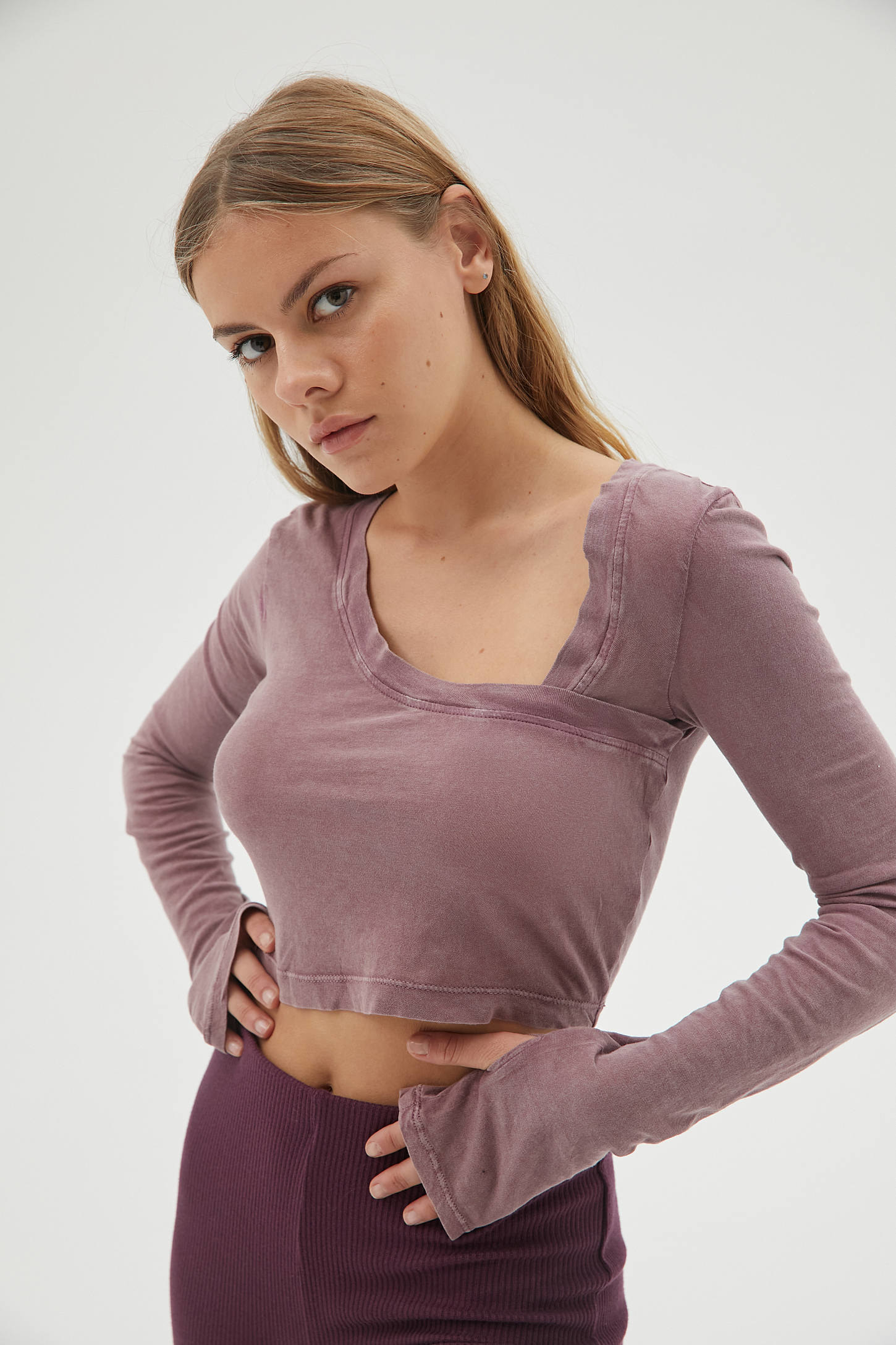 A model wearing the cropped shirt with asymmetric neckline in pink 
