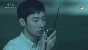 haeyoung curiously looking down at the walkie talkie 