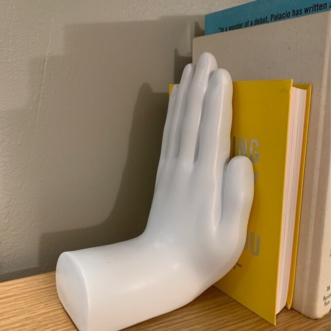 a reviewer's white hand bookend
