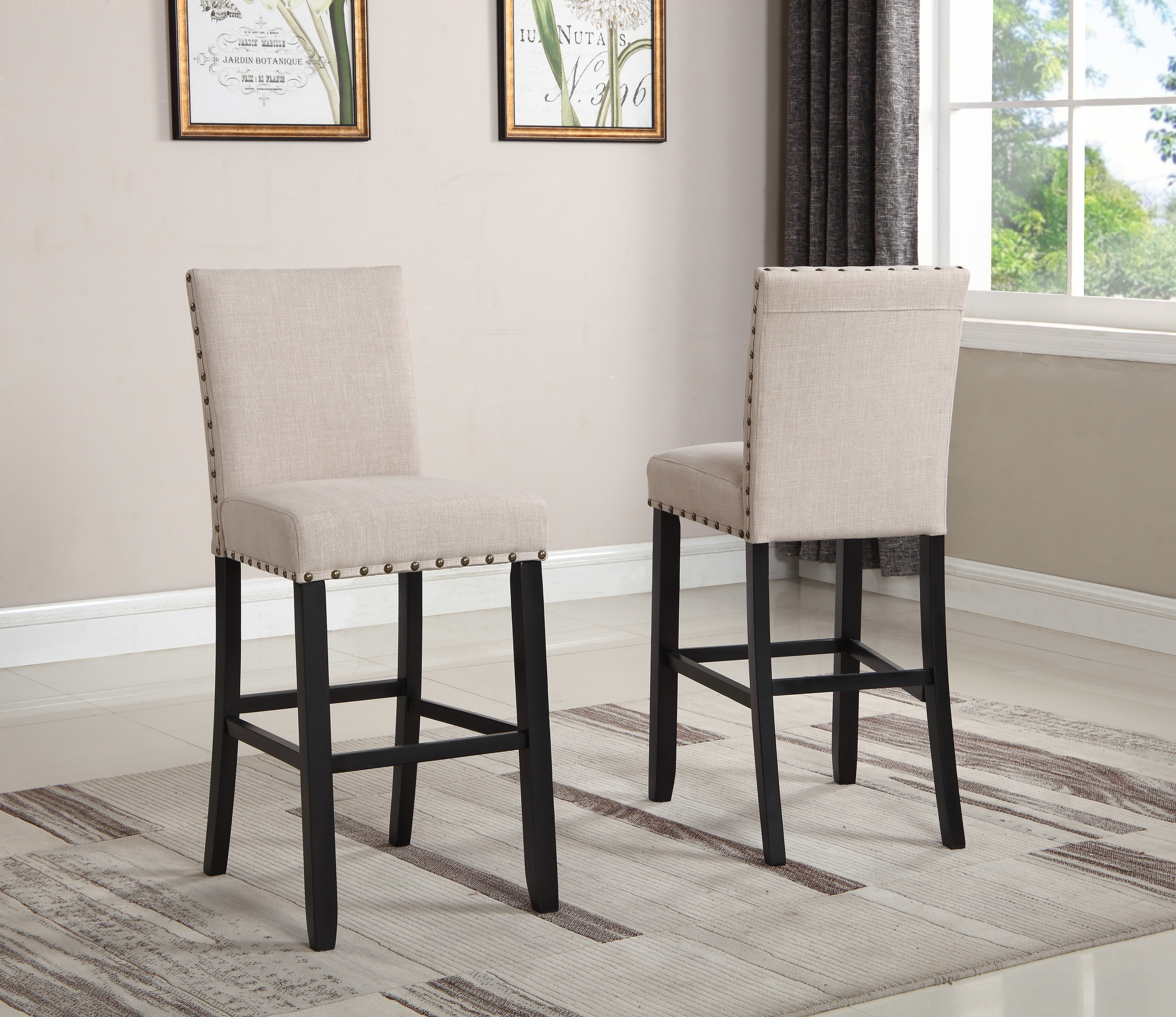 Two tan barstools with stud details