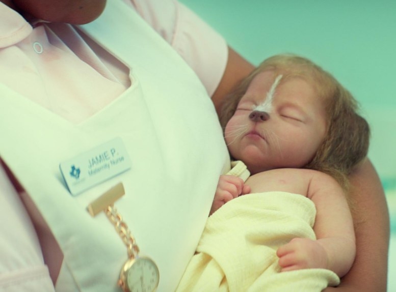 A nurse holds a dog hybrid baby