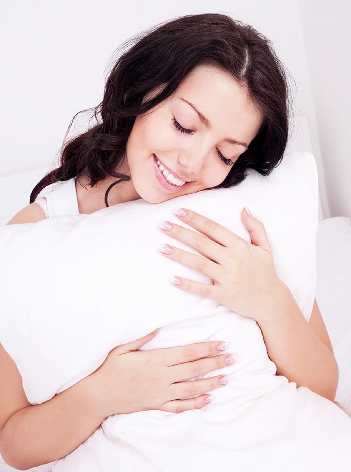 A woman hugging a pillow 