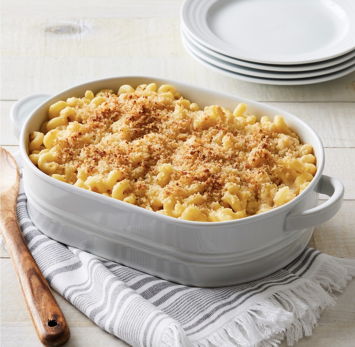 The white tray with handles is holding homemade macaroni and cheese
