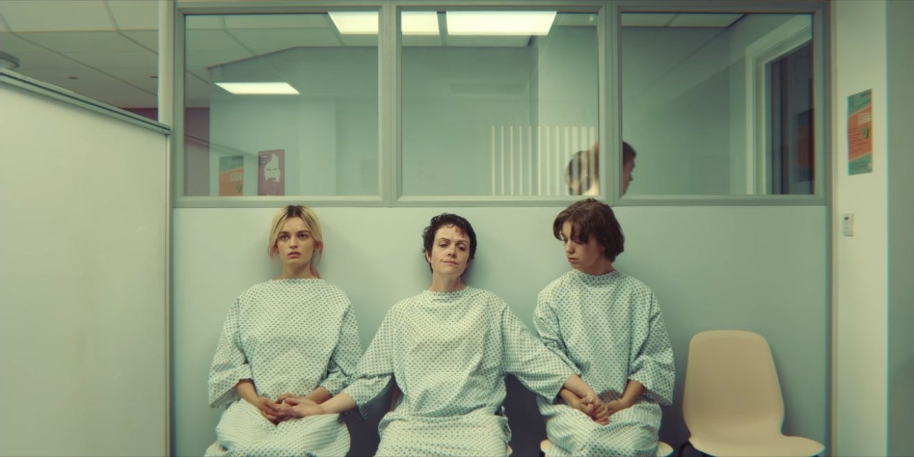 Maeve and two other women hold hands in an abortion clinic