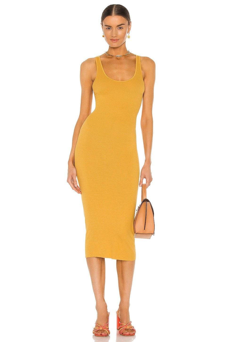 Model wearing yellow tank dress that stops past the knee