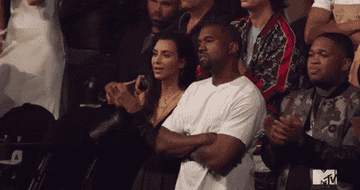Kim Kardashian and Kanye West clap at the 2020 MTV Video Music Awards