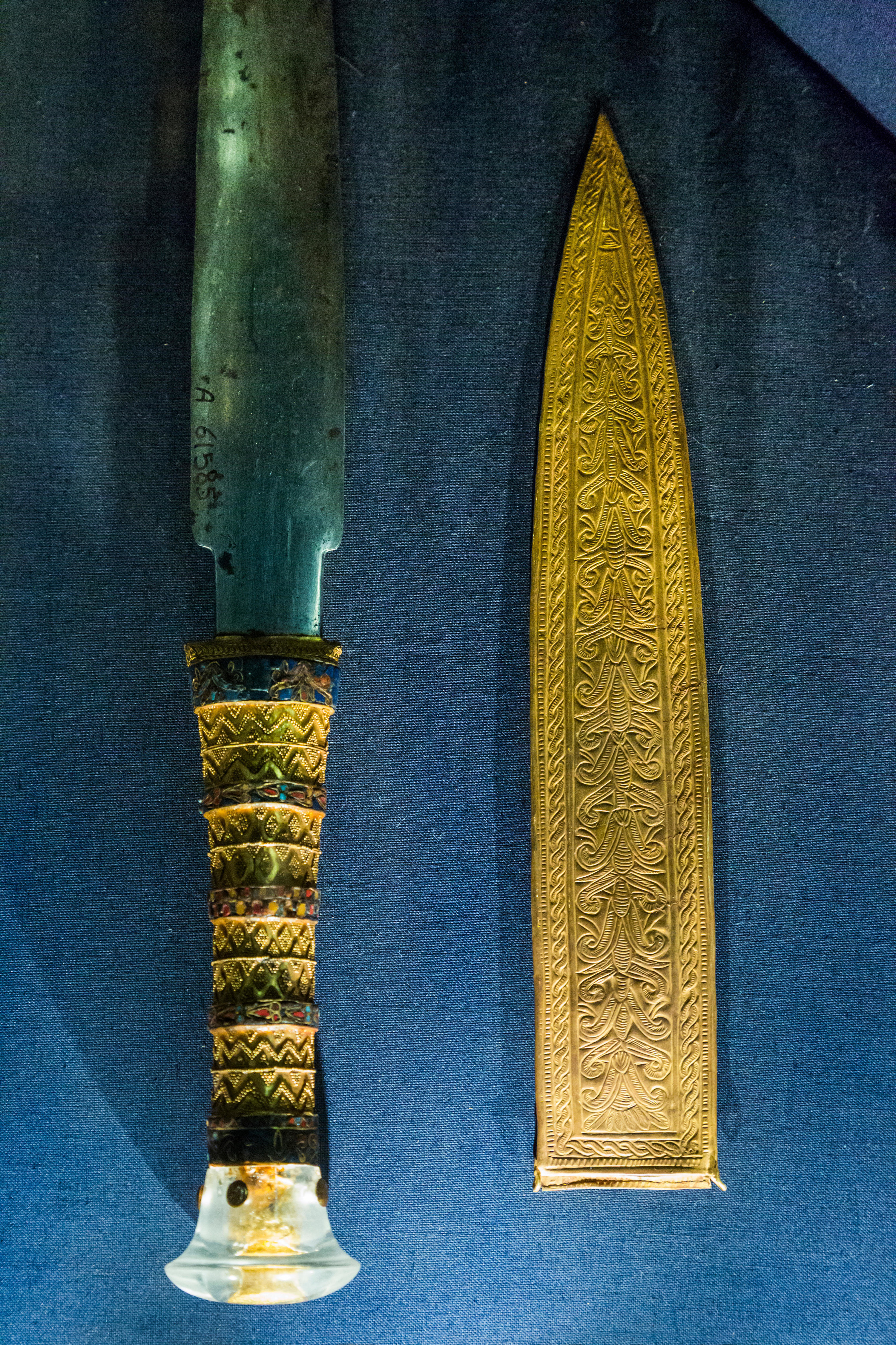 An ancient dagger with a hilt and sheath made of gold
