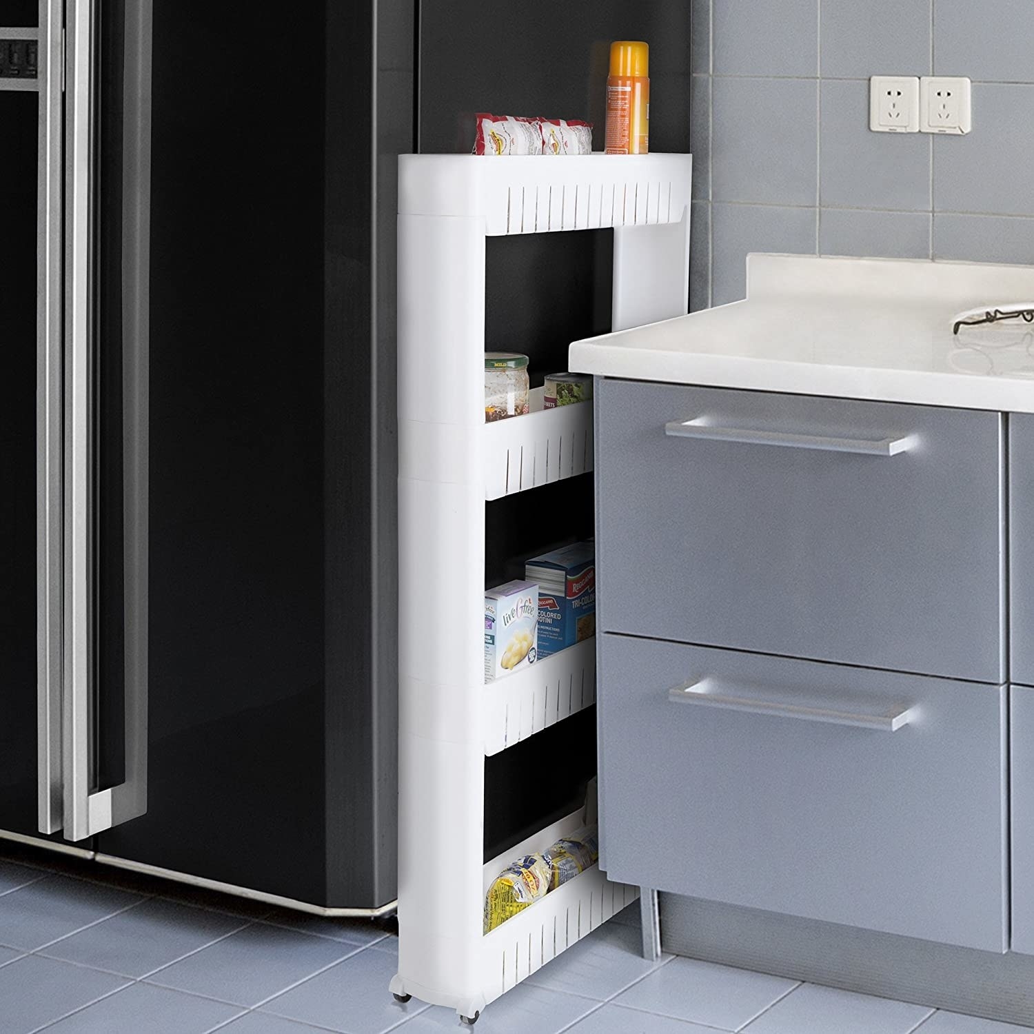 A pull-out storage unit in the gap between a counter and fridge