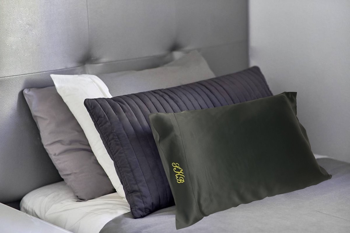 dark silk pillowcase with a monogram on the side