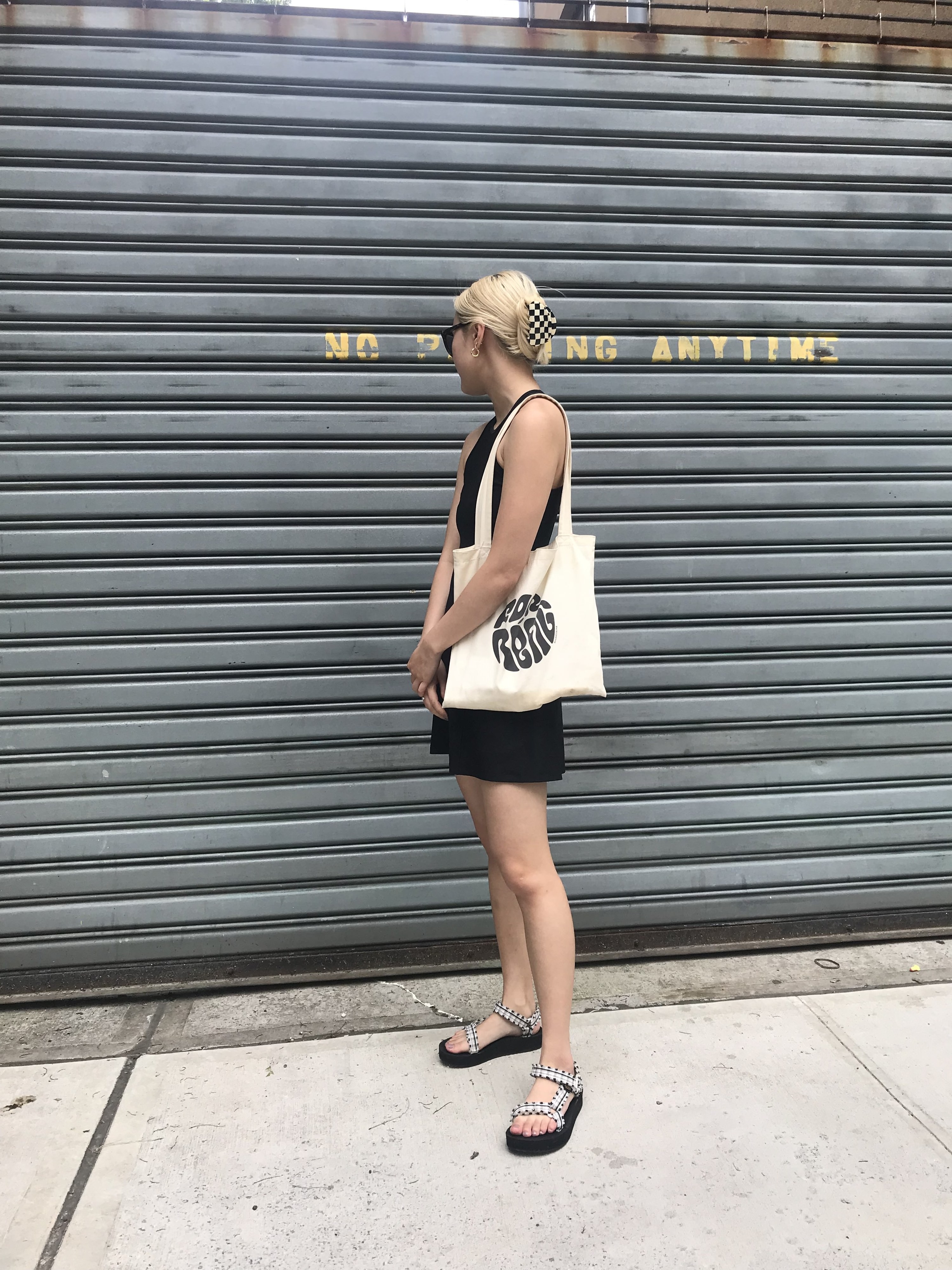 BuzzFeed editor wearing the sandals with a high-neck a-line black dress
