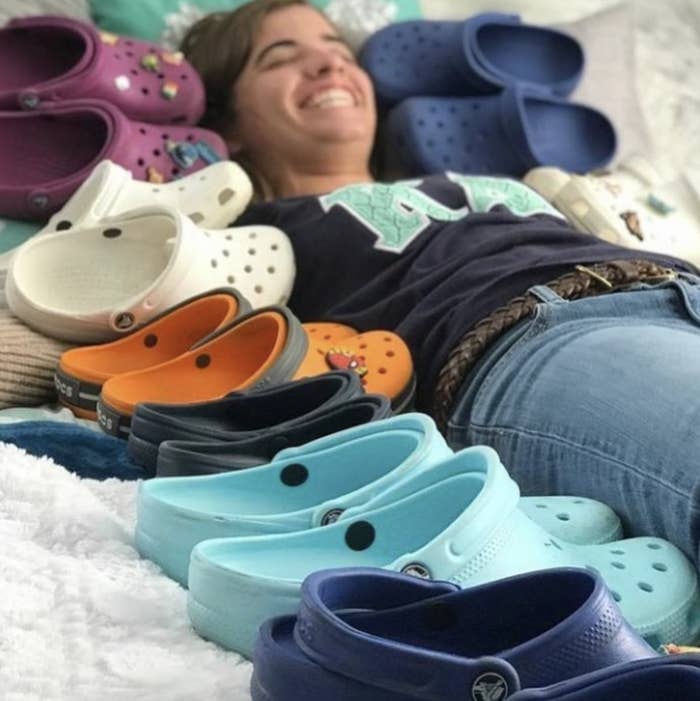 person lying in a bed of crocs
