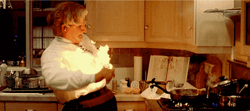 Mrs. Doubtfire cooking and setting food on fire.