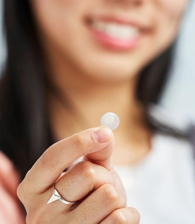 Person holding their pimple patch filled with pus