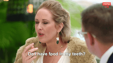 a person saying &quot;do I have food in my teeth?&quot;