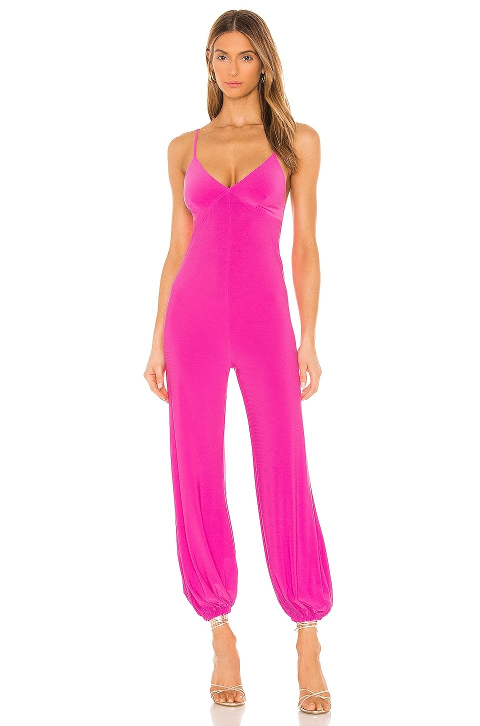Model wearing pink jumpsuit cuffed at the ankles