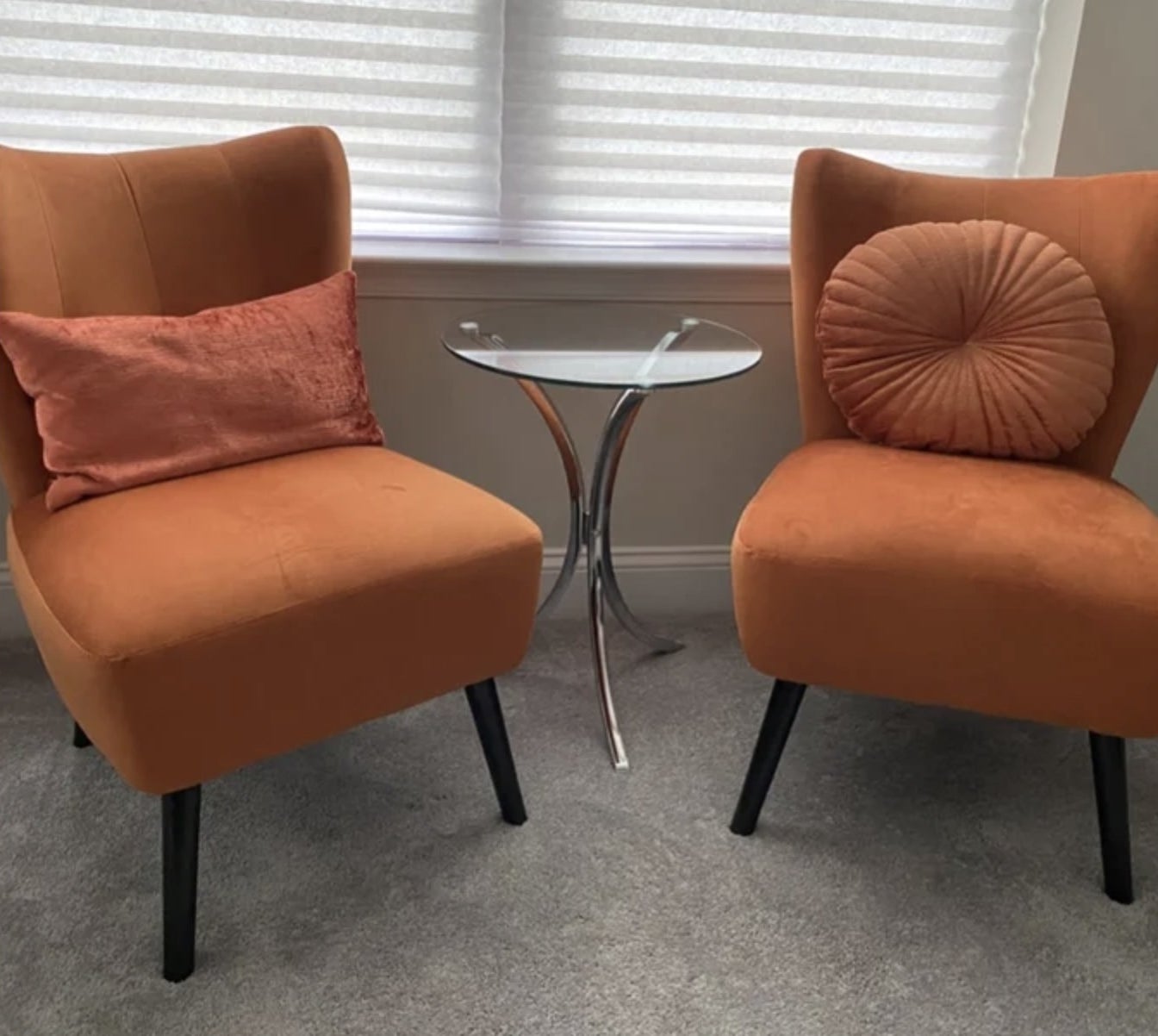 A reviewer&#x27;s set of orange velvet accent chairs