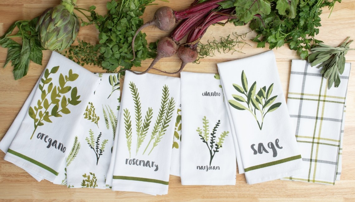 The towels say various spices with watercolor drawing of each one