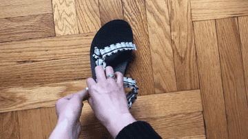 Gif of BuzzFeed editor opening and closing the velcro straps on the ankle and across the toes