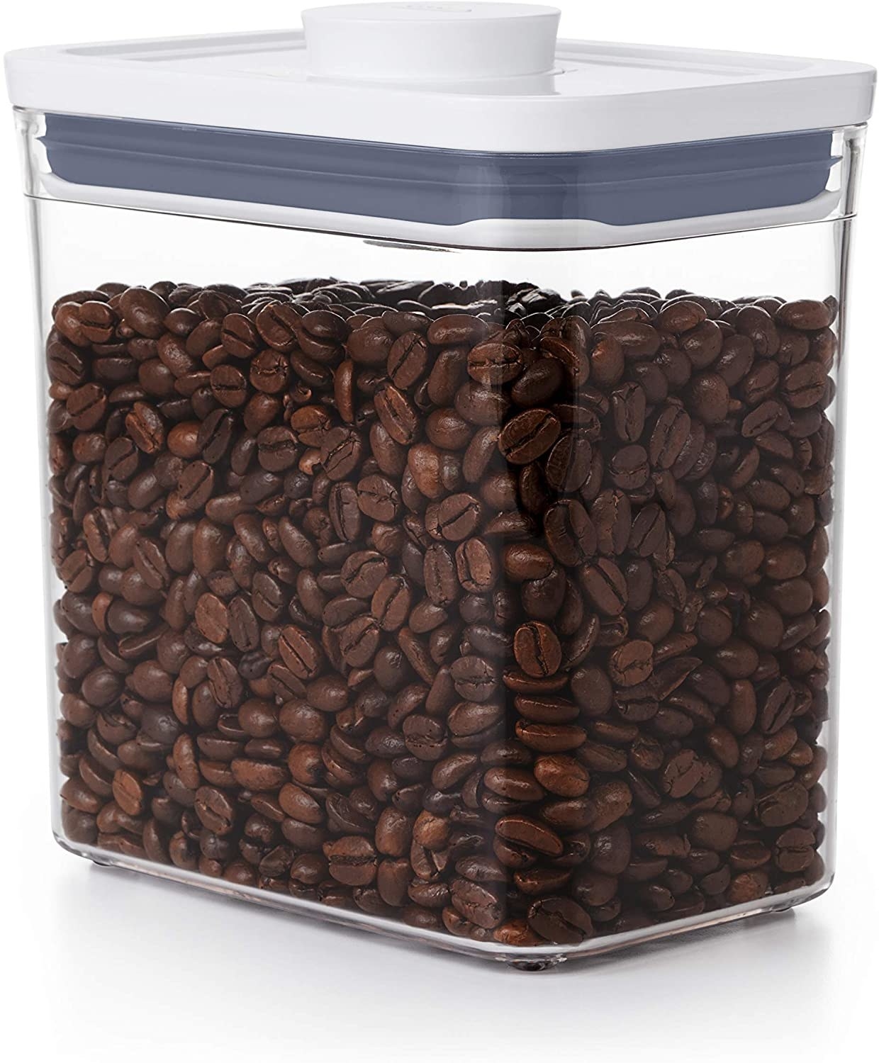 A clear container filled with coffee beans