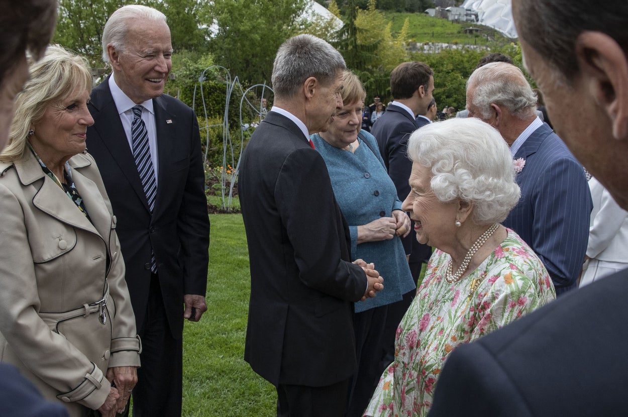 The queen is shown chatting with the Bidens