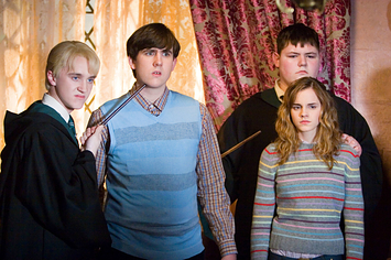 Tom Felton and Jamie Waylett hold Matthew Lewis and Emma Watson hostage in Harry Potter and the Order of the Phoenix