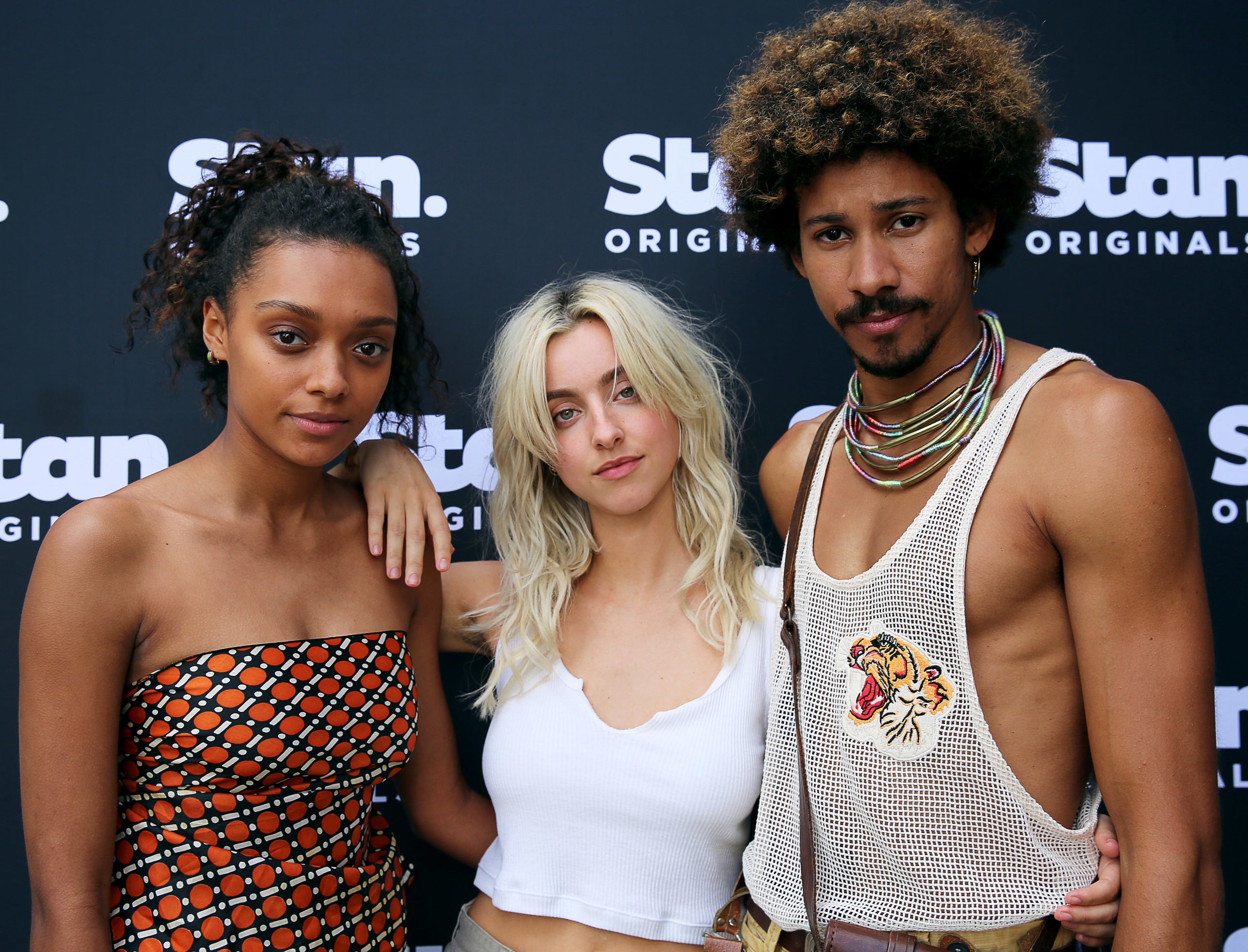 Keiynan Londsale standing next to his Eden co-stars BeBe Bettencourt and Sophie Wilde